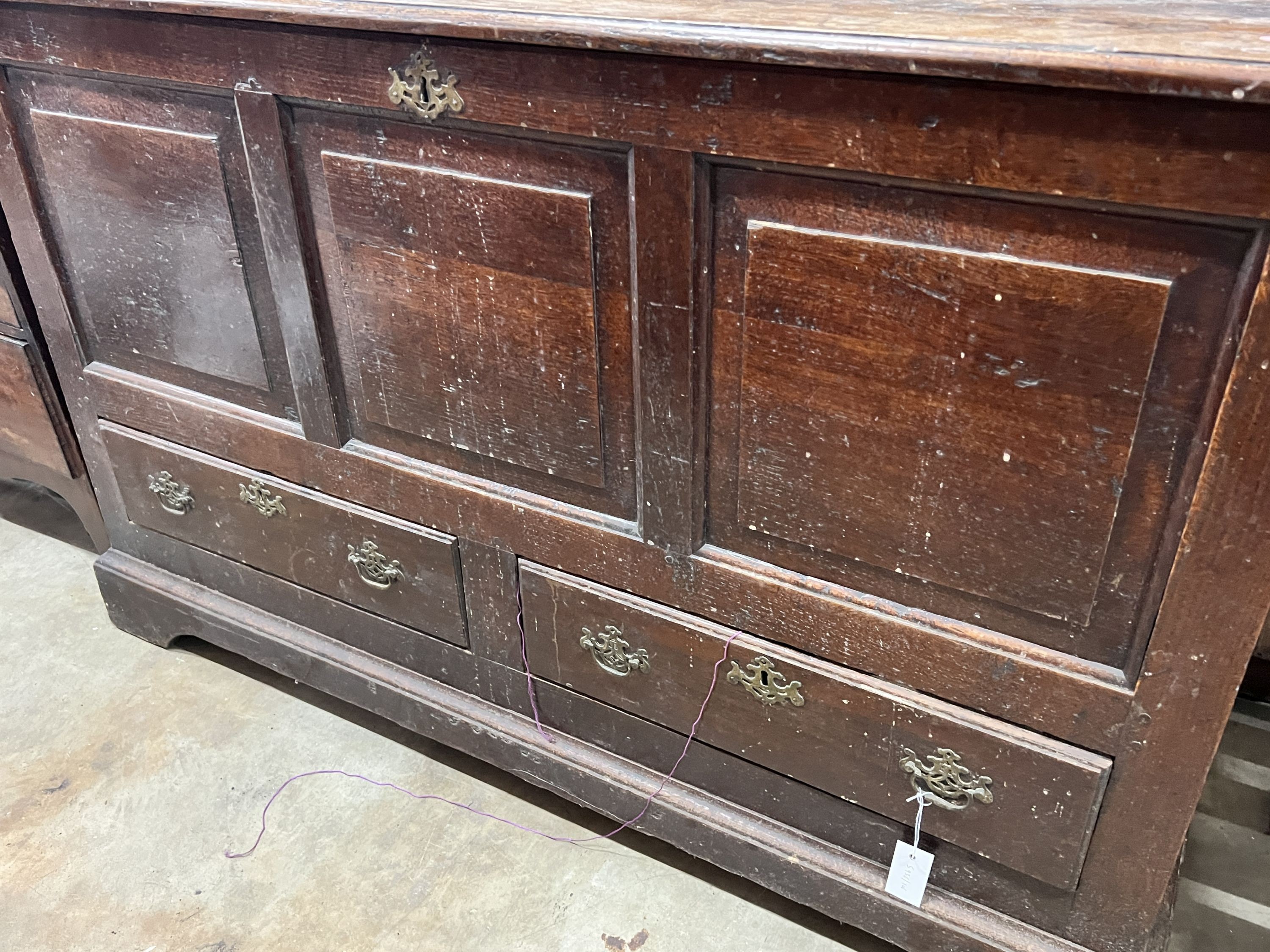 A mid 18th century oak mule chest with squared triple panelled front, width 151cm, depth 50cm, height 90cm